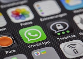 Detailed macro of smartphone screen showcasing popular app icons like WhatsApp.